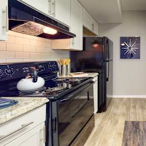 a kitchen with stainless steel appliances and white cabinets
