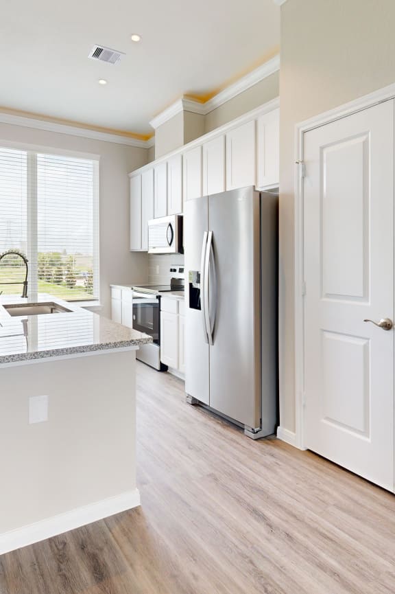 a kitchen with white cabinets and a white counter top