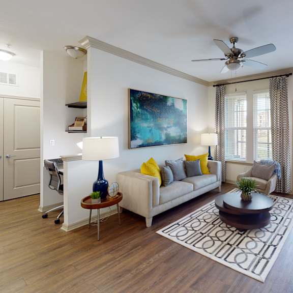 an open concept living room and dining area with a white dining table and rattan chairs at Integra 360 Apartments, Winter Springs, FL, 32708