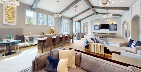 a living room with couches and chairs and a dining room and a kitchen