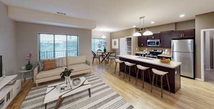 A modern kitchen with a dining table and chairs is visible.