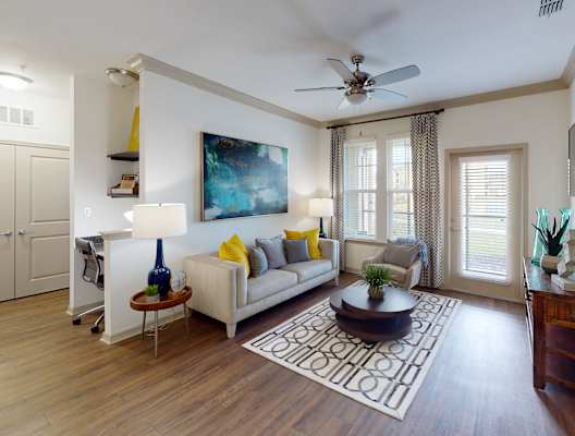 a living room with hardwood floors and a ceiling fan at Integra 360 Apartments, Winter Springs, FL, 32708