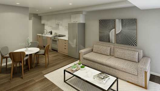 A modern living room with a grey couch and a coffee table.