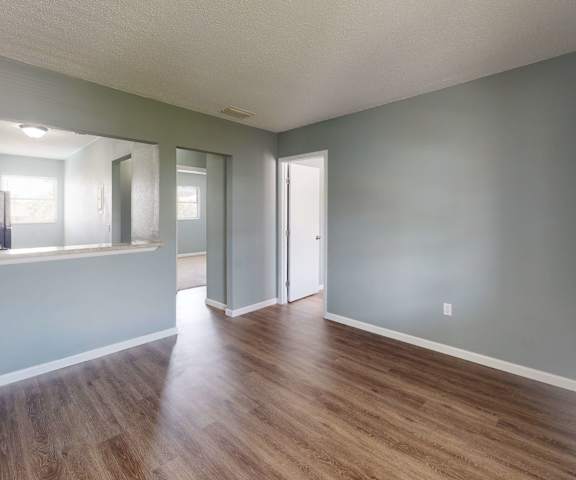 a living area with hardwood flooring and grey walls