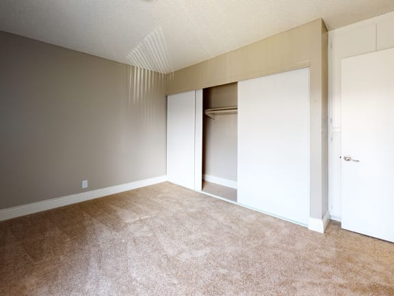 an empty room with a closet and a door to a wardrobe at Avante Apartments, California, 91764