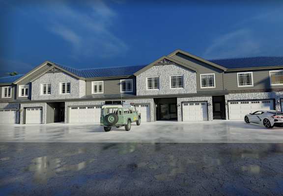 A green toy truck is parked in front of a grey house.