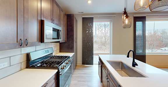 A kitchen with a stove top oven and a microwave above it.