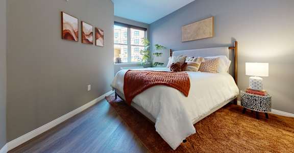 A bedroom with a large bed and a window.