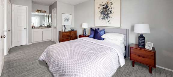 a bedroom with a bed and two night stands