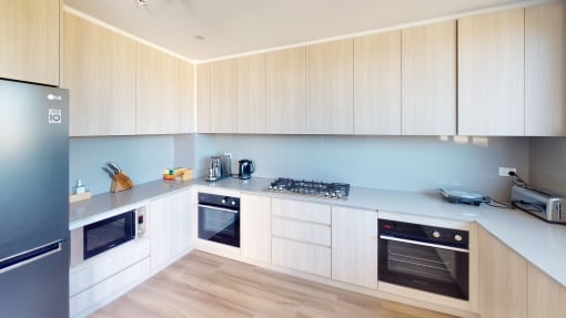 a kitchen with white cabinets and stainless steel appliances