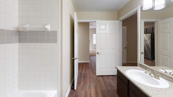 a bathroom with a sink and a shower and a mirror at The Legends at Eagle Mountain Lake, Fort Worth