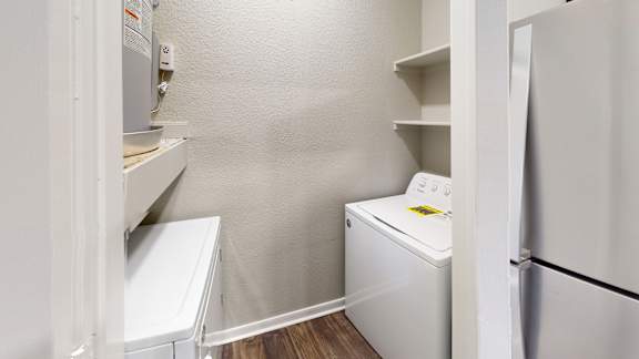 a small laundry room with a washer and dryer and a refrigerator at The Legends at Eagle Mountain Lake, Fort Worth, 76179