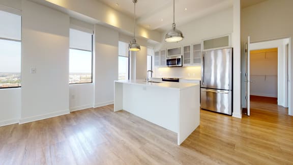 a kitchen with stainless steel appliances and a large window