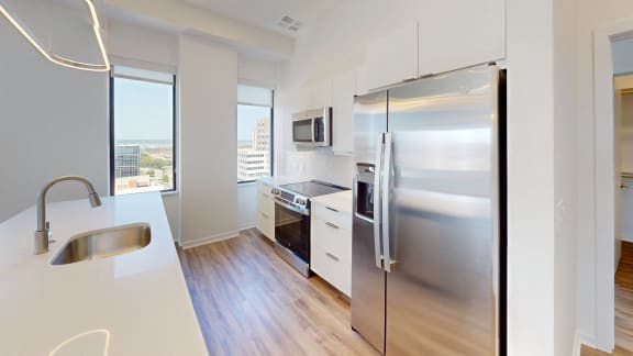 a kitchen with stainless steel appliances and a large window