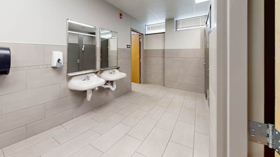 A bathroom with two sinks and a mirror.