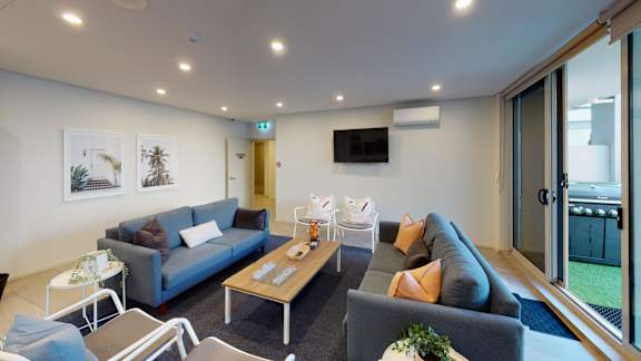a living room with couches and chairs and a table