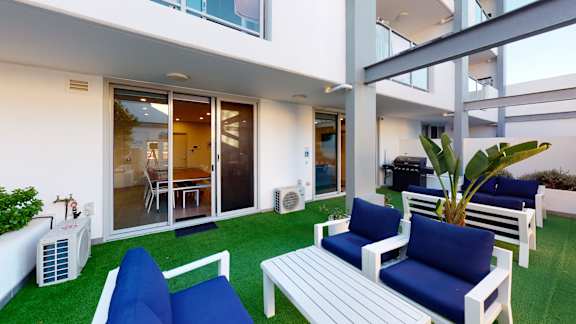 a living room with blue furniture and green grass