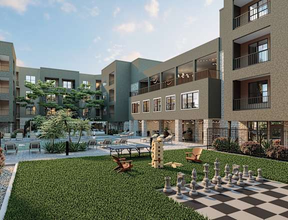 A chess board is set up on a grassy area in front of apartment buildings. at Refinery at Pointe17 Apartments, Phoenix, AZ, 85085