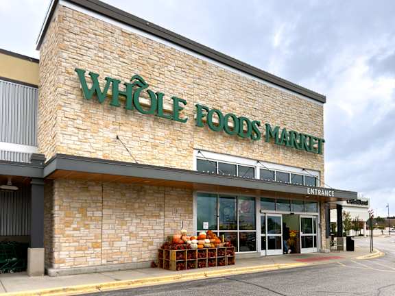 A Whole Foods Market storefront with a stone facade and a sign above the entrance.