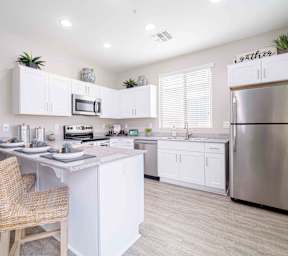 A swimming pool surrounded by palm trees and a house at Vistoria At Country Place Apartments, Tolleson