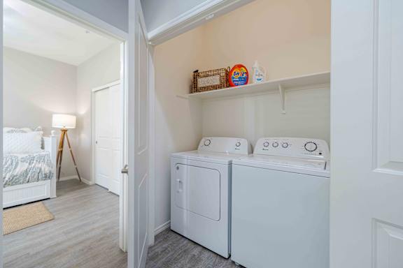 A small laundry room with a washer and dryer at Vistoria At Country Place Apartments, Tolleson, 85353