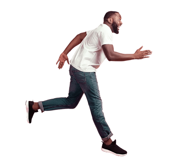 A man in a white shirt and jeans is running.