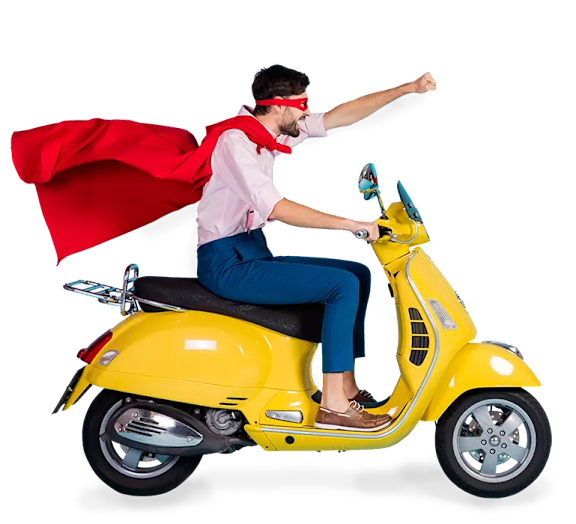 A man in a red cape is riding a yellow scooter.