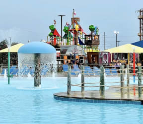 a water park with a water fountain in the middle