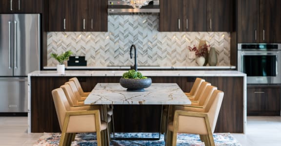 a rendering of a room with a round table and a chandelier in front of a at The Clearing at ONE28, Olathe
