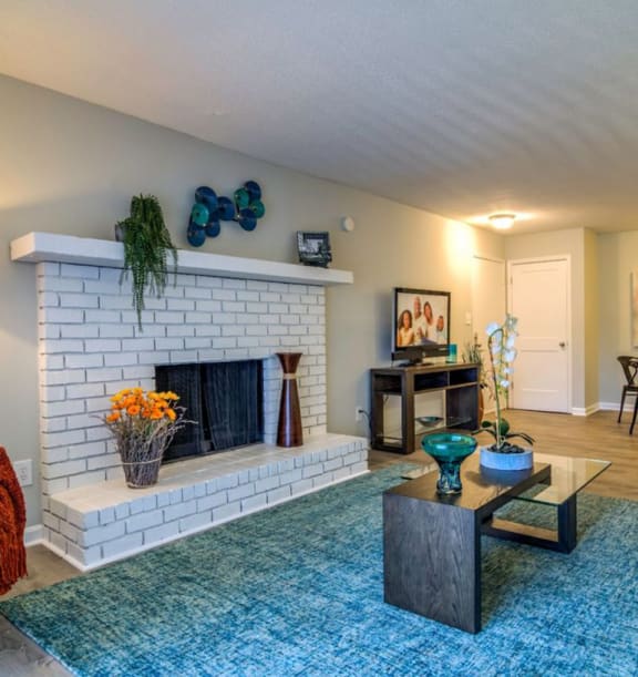 Brick fireplace in living room at The Onyx Hoover Apartments