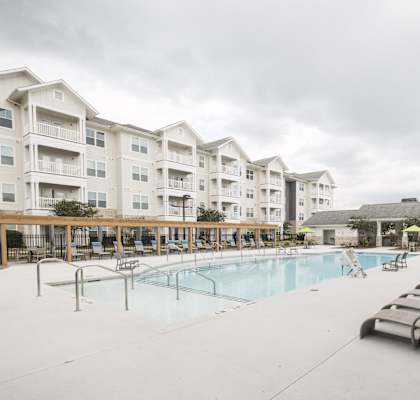the preserve at ballantyne commons pool with lounge chairs and apartment buildings