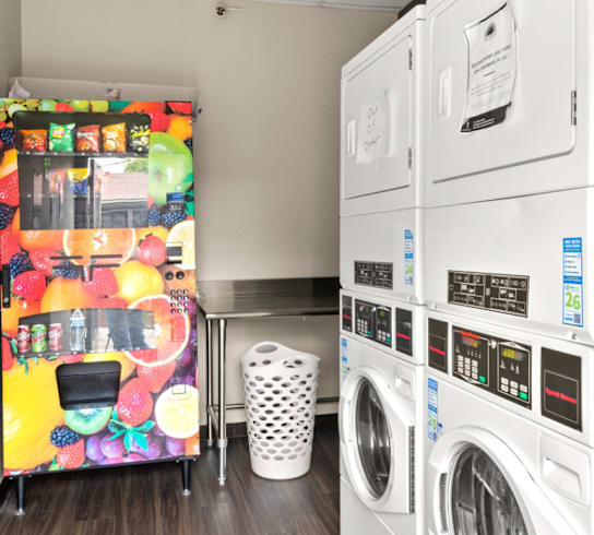 A laundry room with a washer and dryer stacked on top of each other.