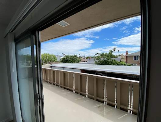 a balcony with a view of a blue sky