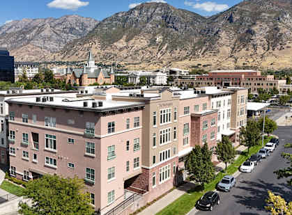 A large building with a parking lot in front of it.