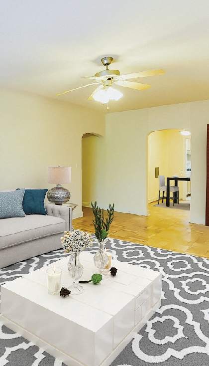 a living room with a white couch and a white coffee table