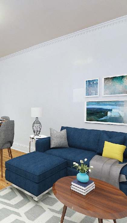 a living room with a blue couch and a dining room table