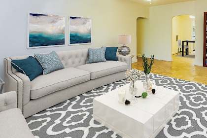a living room with a white couch and a white coffee table