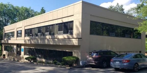 a building with two cars parked in front of it