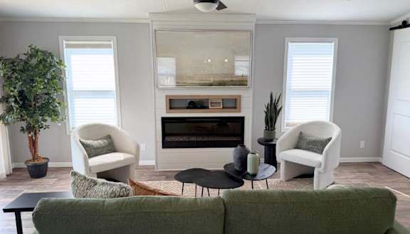 A modern kitchen with a black stove top oven and white cabinets.