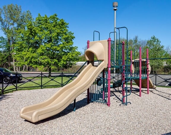 A playground with a slide and climbing bars.
