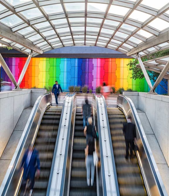 people are riding up and down an escalator