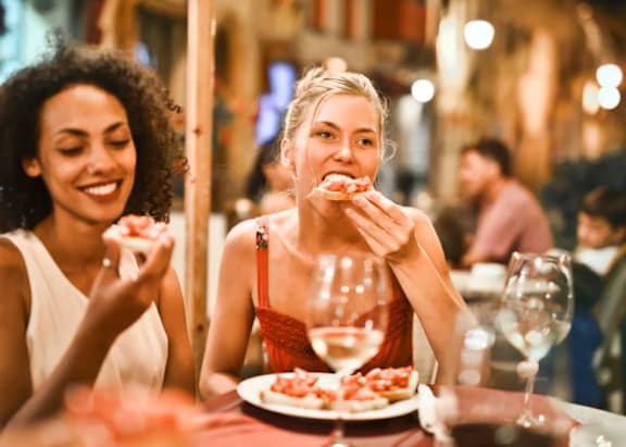 Two women enjoying a meal together at a restaurant.