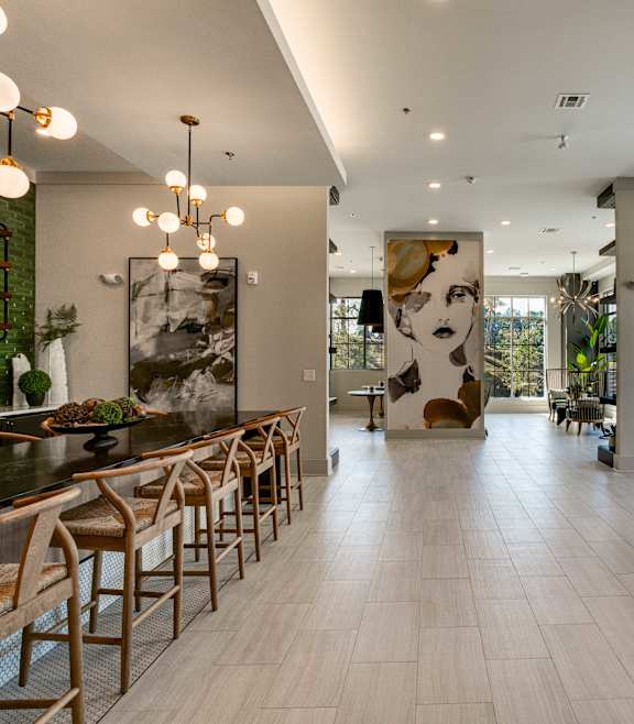 an image of a kitchen with a black island and bar stools