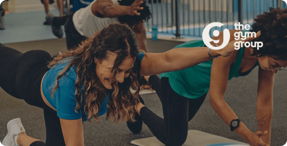 a group of people doing yoga in a gym