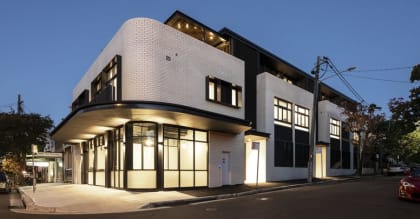 a white and black building on the corner of a street