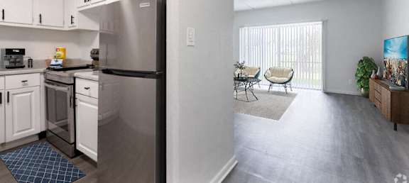 an open kitchen with stainless steel appliances and a living room with a sliding glass door