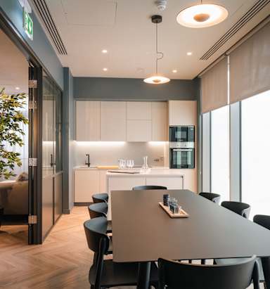 A modern kitchen with a dining table and chairs.