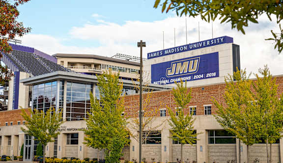 James Madison University building with a banner that says "JMU CHAMPIONS! 2004 | 2016".