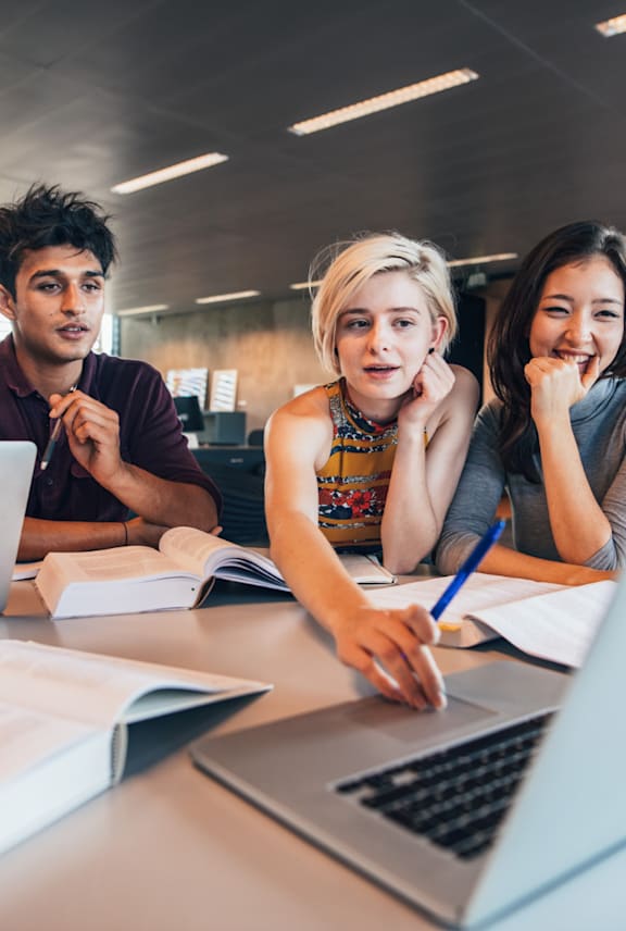 Friends Studying Together and Looking at Laptop