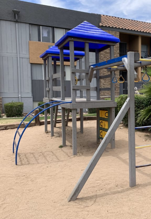 a swing set in a playground in front of a building